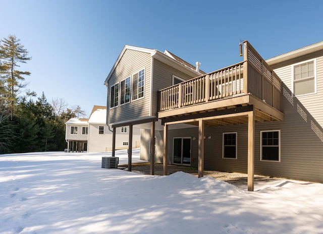 snow covered property featuring a wooden deck and central air condition unit