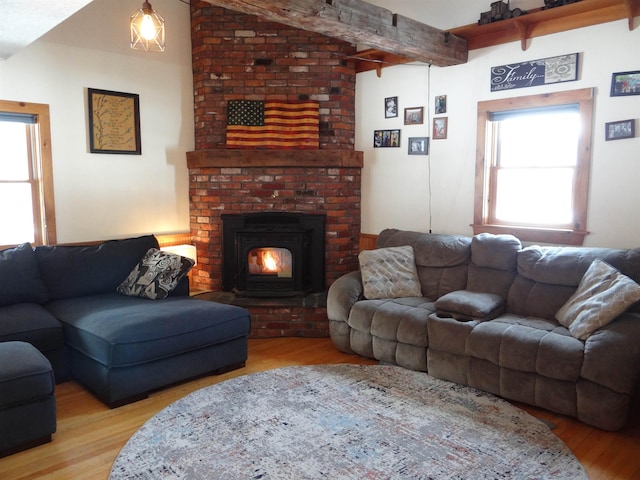 living room featuring lofted ceiling with beams and light wood-type flooring