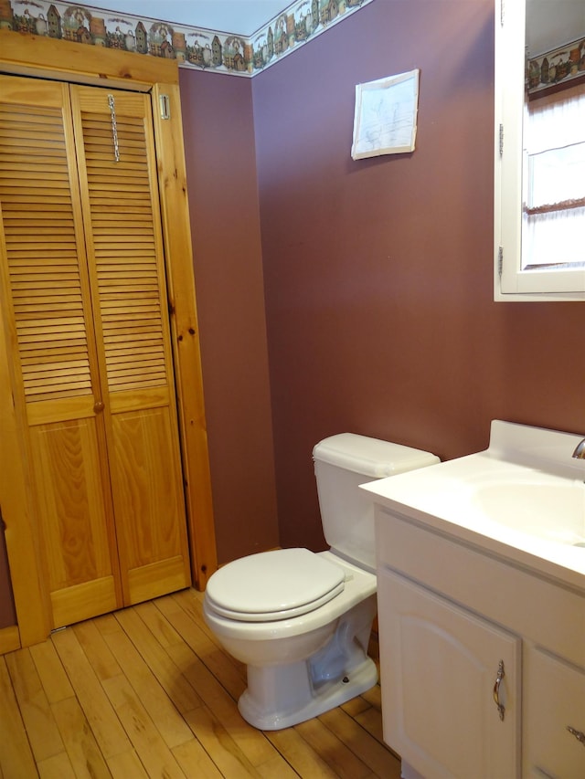 bathroom with vanity, hardwood / wood-style floors, and toilet