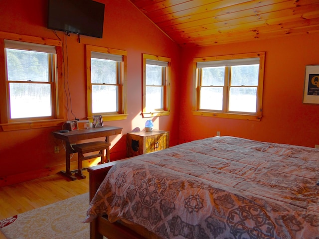 bedroom featuring hardwood / wood-style flooring, wood ceiling, and vaulted ceiling