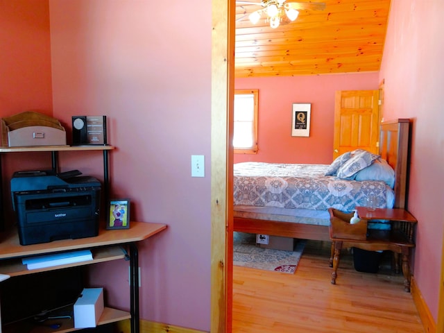 bedroom featuring vaulted ceiling, wooden ceiling, and light hardwood / wood-style flooring