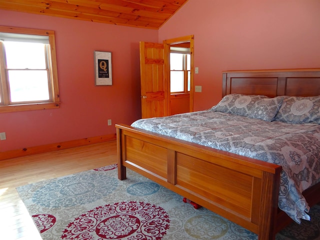 bedroom with wood ceiling, vaulted ceiling, and light wood-type flooring