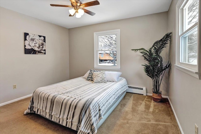 bedroom with light carpet, a baseboard radiator, and ceiling fan