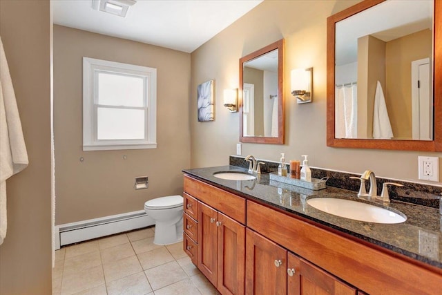 bathroom featuring tile patterned floors, toilet, vanity, and a baseboard heating unit