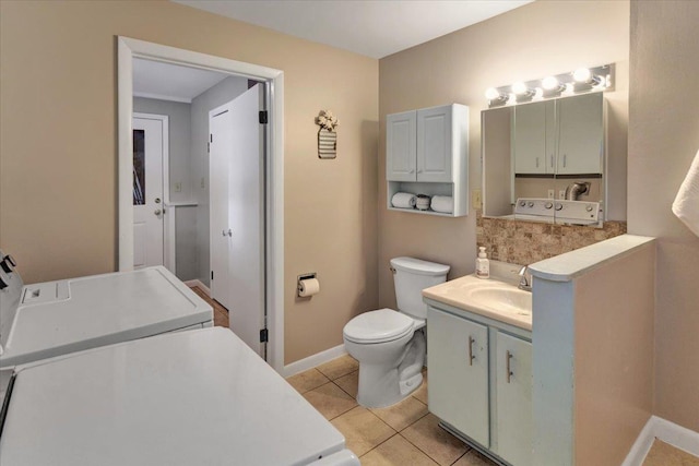 bathroom with tile patterned flooring, vanity, and toilet