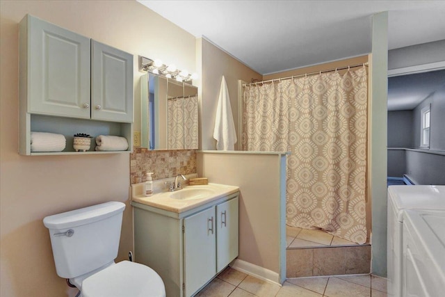 bathroom with independent washer and dryer, vanity, curtained shower, tile patterned floors, and toilet