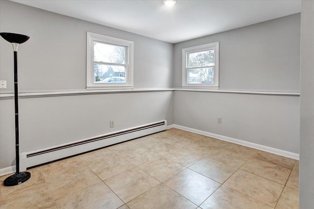 unfurnished room featuring a baseboard heating unit and light tile patterned flooring