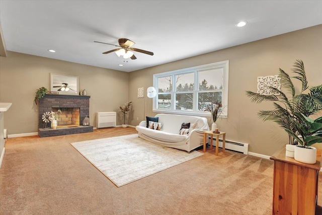 carpeted living room with ceiling fan, a brick fireplace, and baseboard heating