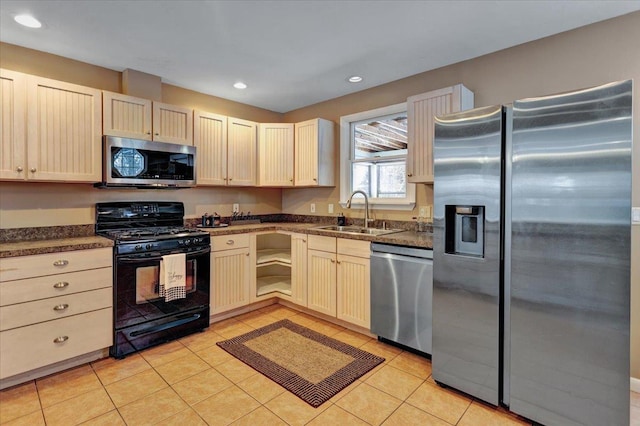 kitchen with appliances with stainless steel finishes, sink, and light tile patterned floors