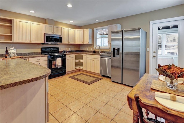 kitchen featuring stainless steel appliances, sink, and light tile patterned floors