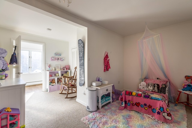 carpeted bedroom with ornamental molding and a baseboard heating unit