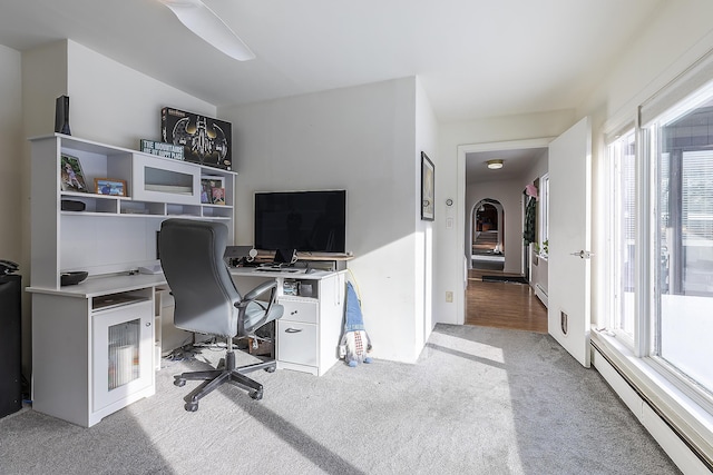 home office featuring a baseboard heating unit and light colored carpet