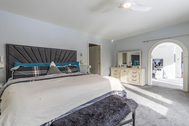 carpeted bedroom featuring lofted ceiling and ceiling fan