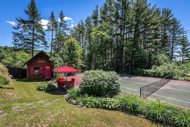 view of yard featuring an outbuilding and tennis court