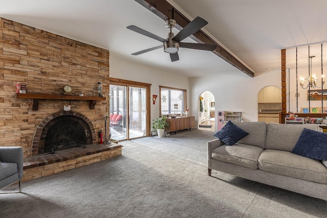 unfurnished living room with light carpet, ceiling fan with notable chandelier, a fireplace, and beam ceiling