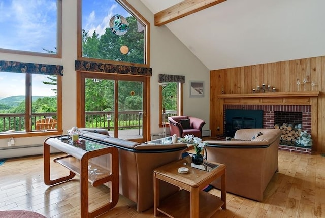 living room featuring high vaulted ceiling, a fireplace, beamed ceiling, plenty of natural light, and light wood-type flooring