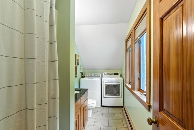 laundry room featuring independent washer and dryer, a baseboard radiator, and light tile patterned floors