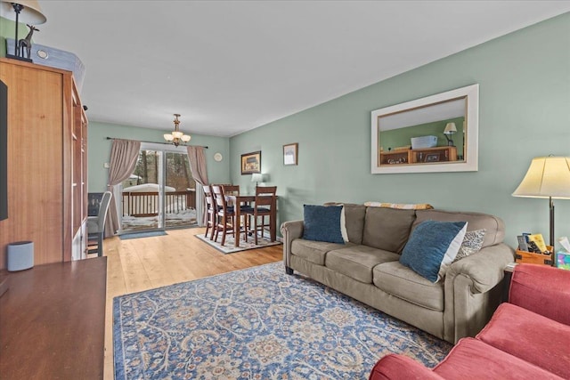 living room featuring hardwood / wood-style flooring and an inviting chandelier