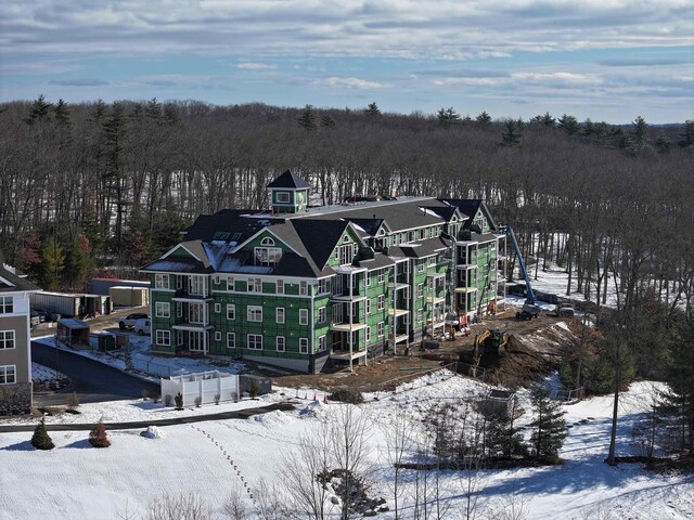 view of snow covered back of property
