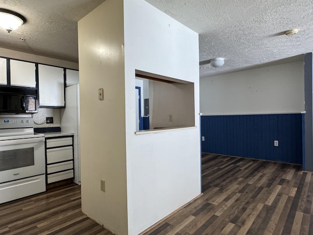 kitchen with a textured ceiling, dark wood-type flooring, white appliances, and tasteful backsplash