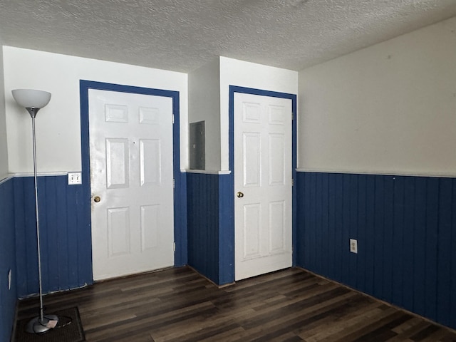 interior space with dark wood-type flooring and a textured ceiling