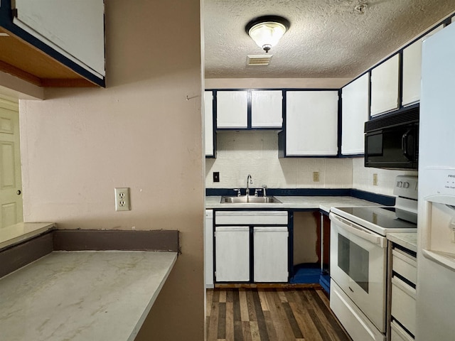 kitchen with white appliances, backsplash, dark hardwood / wood-style flooring, sink, and white cabinetry