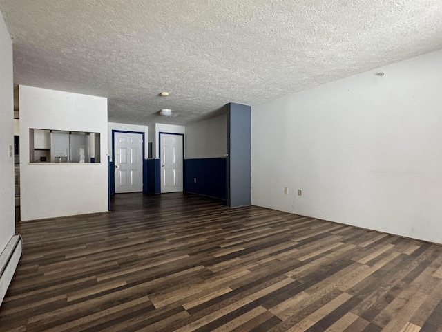 unfurnished living room with dark hardwood / wood-style flooring, a textured ceiling, and baseboard heating