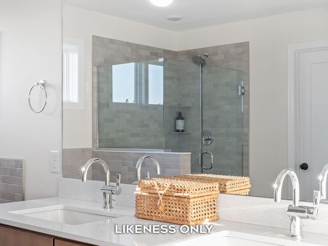 bathroom featuring vanity, an enclosed shower, and backsplash