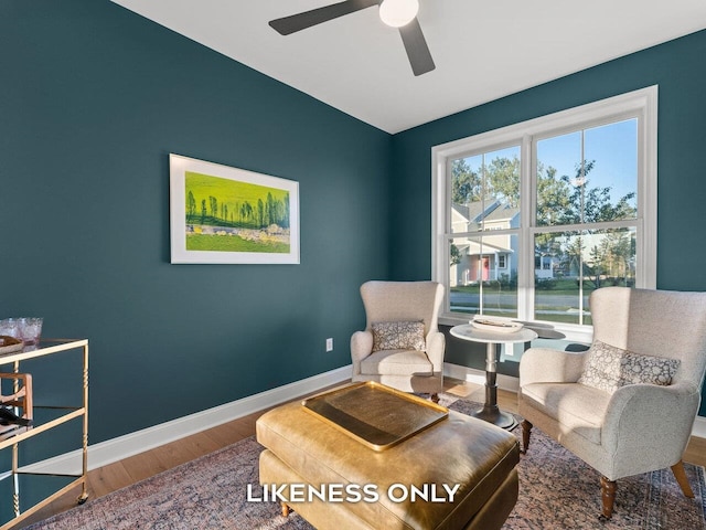 sitting room featuring hardwood / wood-style floors and ceiling fan