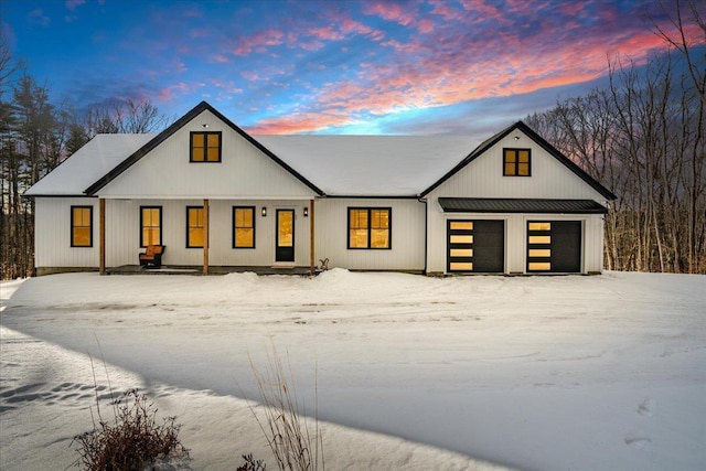 modern inspired farmhouse with a garage