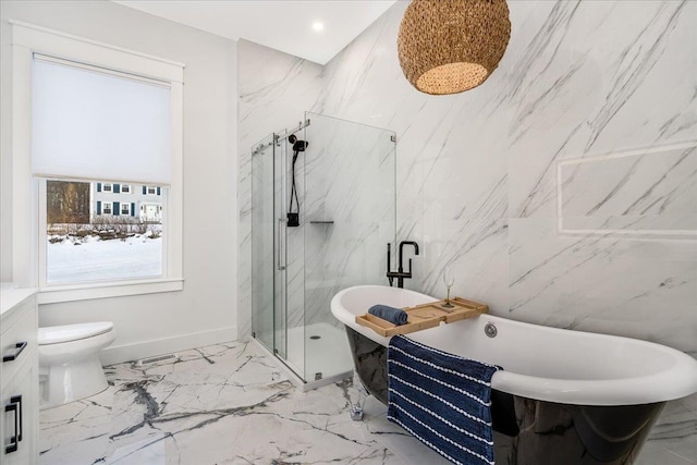 full bathroom with a marble finish shower, toilet, tile walls, a freestanding tub, and marble finish floor