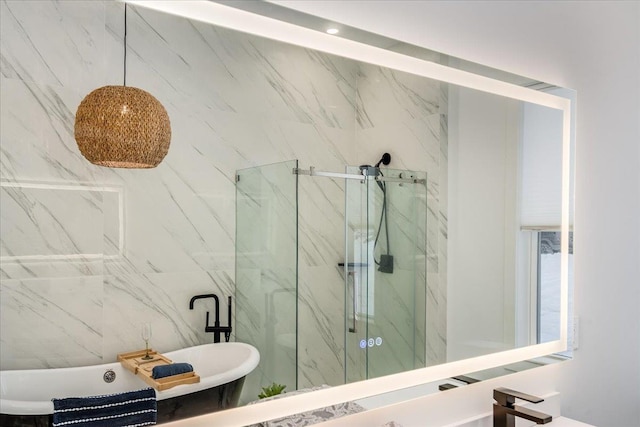 bathroom with a marble finish shower and a soaking tub