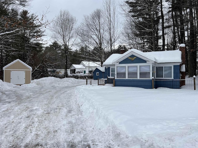 yard layered in snow with a storage unit