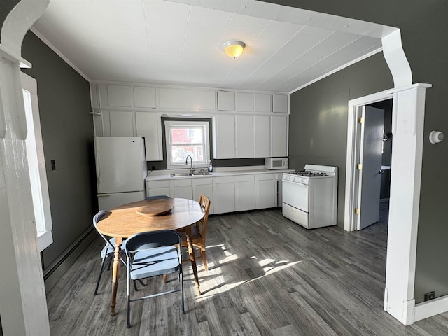 kitchen featuring crown molding, sink, white appliances, and white cabinets