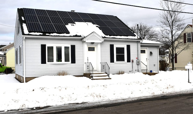 view of front facade featuring solar panels