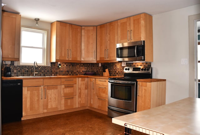 kitchen with concrete flooring, tasteful backsplash, stainless steel appliances, and a sink