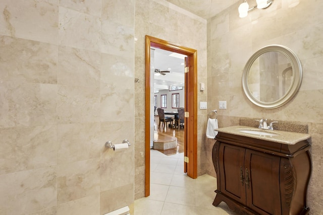 bathroom with tile patterned flooring, vanity, and tile walls