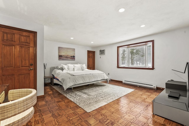 bedroom featuring an AC wall unit and baseboard heating