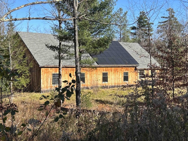 exterior space with roof mounted solar panels