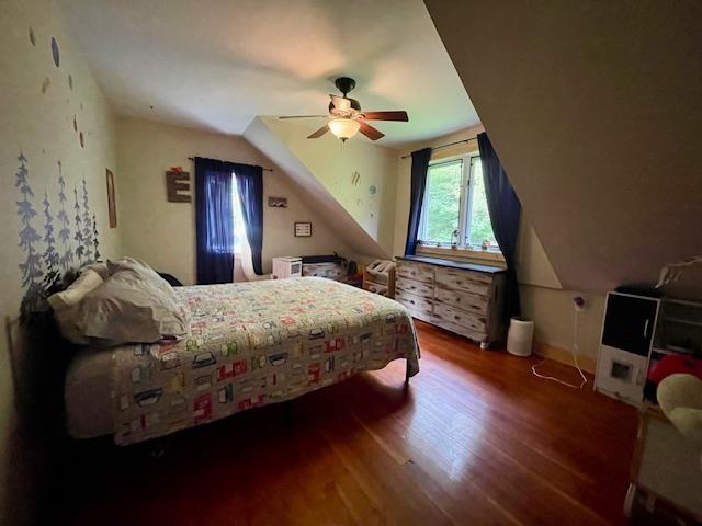 bedroom with dark wood-type flooring and ceiling fan