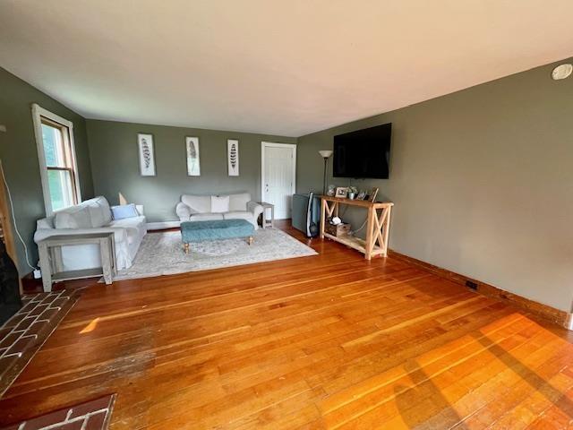 unfurnished living room with hardwood / wood-style flooring