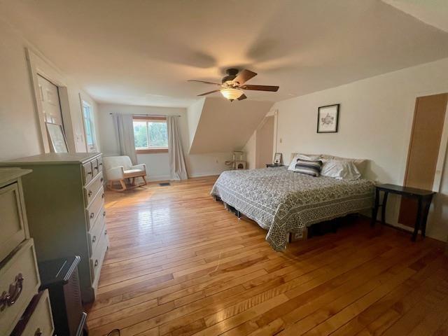 bedroom with light hardwood / wood-style floors and ceiling fan