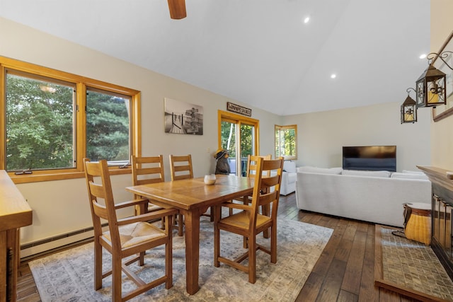 dining space with lofted ceiling, hardwood / wood-style flooring, and a baseboard radiator