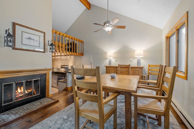 dining room featuring high vaulted ceiling, beamed ceiling, ceiling fan, hardwood / wood-style floors, and a baseboard heating unit