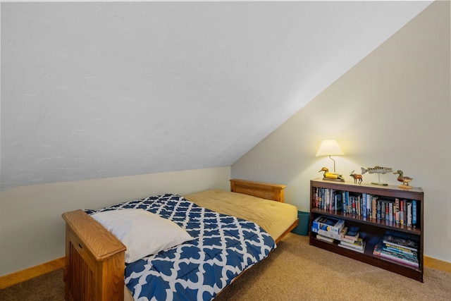 bedroom featuring lofted ceiling and carpet floors