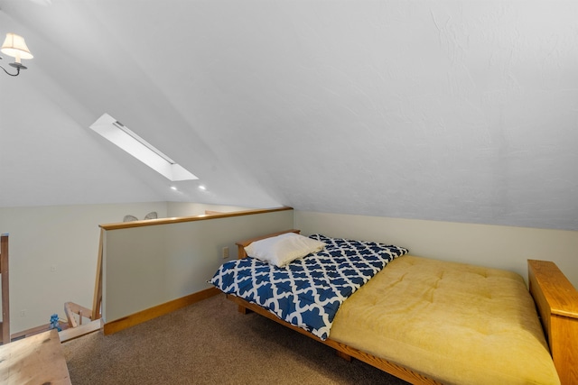 carpeted bedroom featuring lofted ceiling with skylight