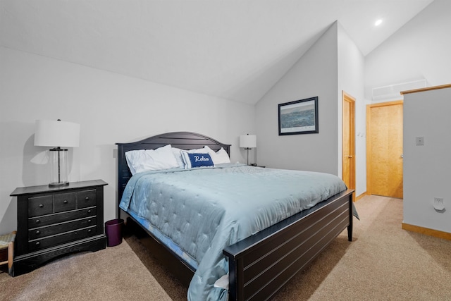 carpeted bedroom with lofted ceiling