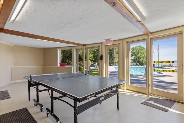 rec room with a textured ceiling