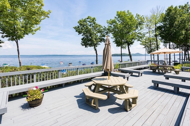 exterior space featuring a deck with water view