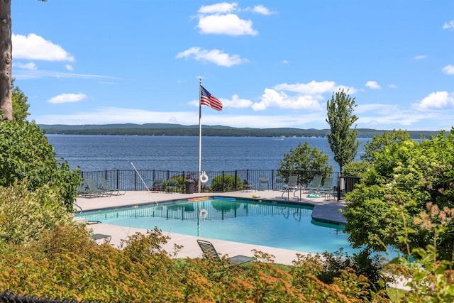 view of swimming pool featuring a water and mountain view and a patio